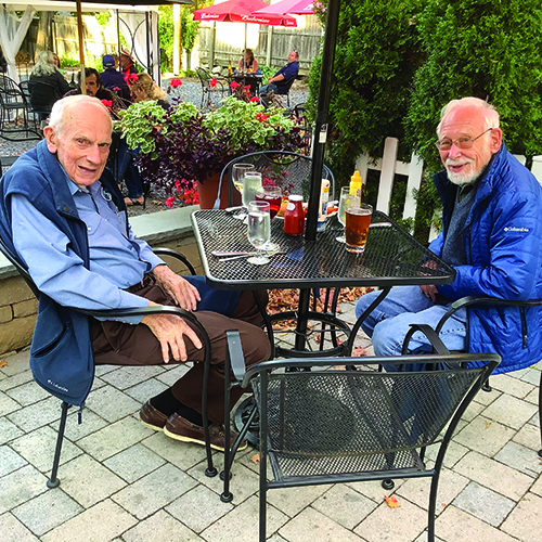 Hu Barnes and friend smiling sitting at a table