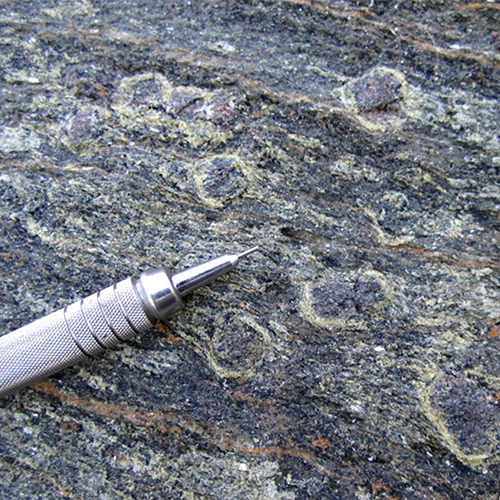 a pen tip sitting on rocks